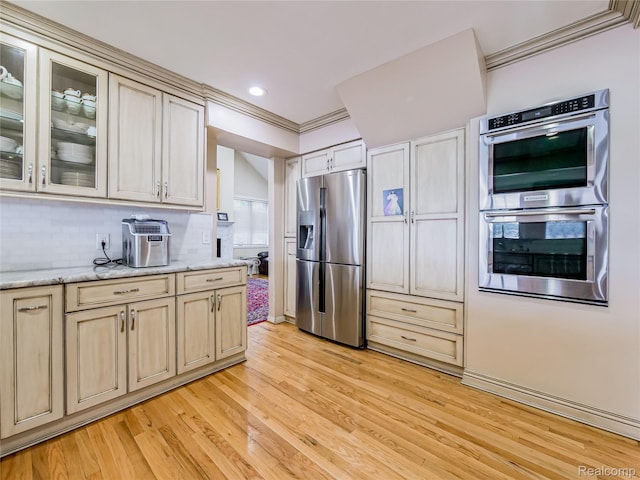 7660 Barnsbury Dr, West Bloomfield, MI 48324 - kitchen with stainless steel appliances, light wood-style floors, glass insert cabinets, backsplash, and light stone countertops