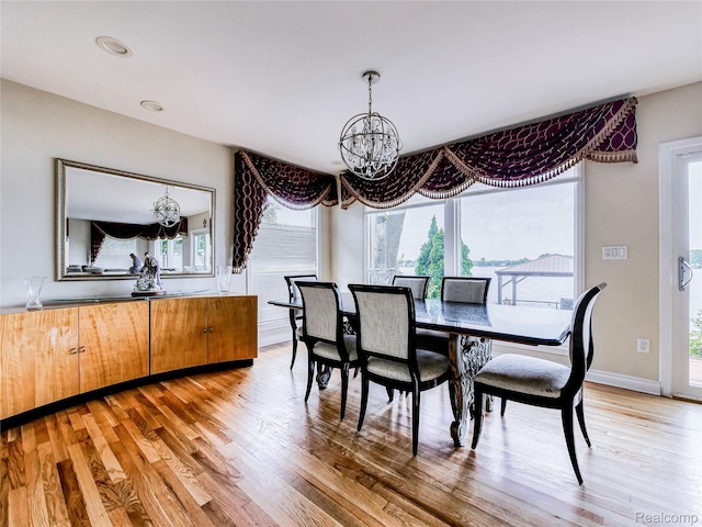 7660 Barnsbury Dr, West Bloomfield, MI 48324 - dining space with a chandelier, plenty of natural light, and light wood-style floors