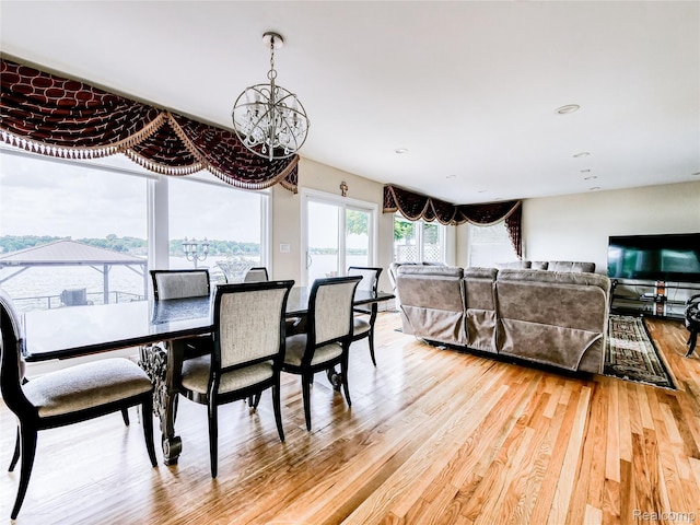7660 Barnsbury Dr, West Bloomfield, MI 48324 - dining room featuring a chandelier and light wood-type flooring