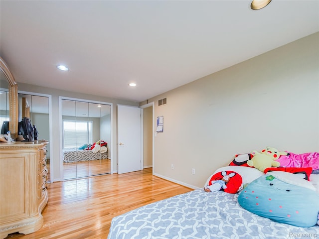 7660 Barnsbury Dr, West Bloomfield, MI 48324 - bedroom with two closets, light wood-style floors, and recessed lighting