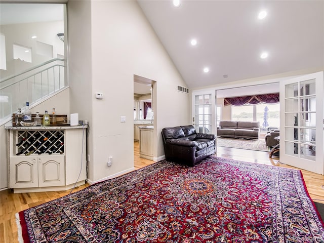 7660 Barnsbury Dr, West Bloomfield, MI 48324 - living room featuring light wood finished floors, high vaulted ceiling, plenty of natural light, stairway, and recessed lighting