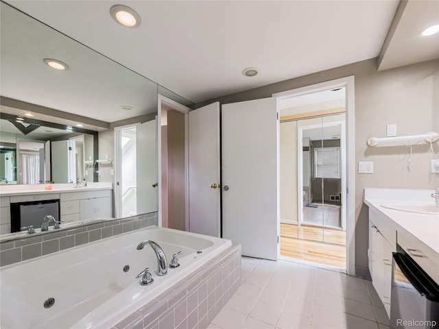 7660 Barnsbury Dr, West Bloomfield, MI 48324 - full bathroom featuring a jetted tub, vanity, and recessed lighting