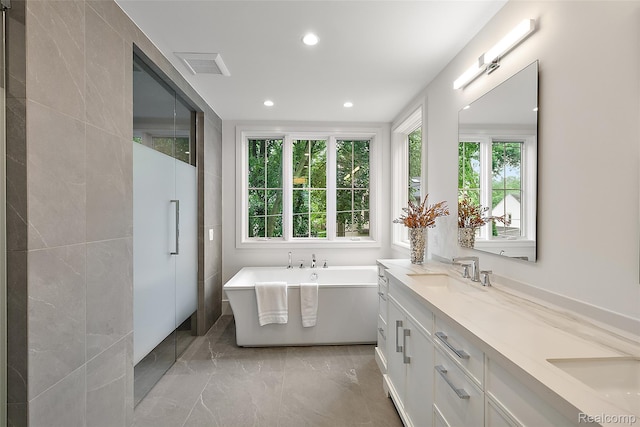 345 Kimberly St, Birmingham, MI 48009 - bathroom with a freestanding tub, double vanity, marble tiled floors, and recessed lighting