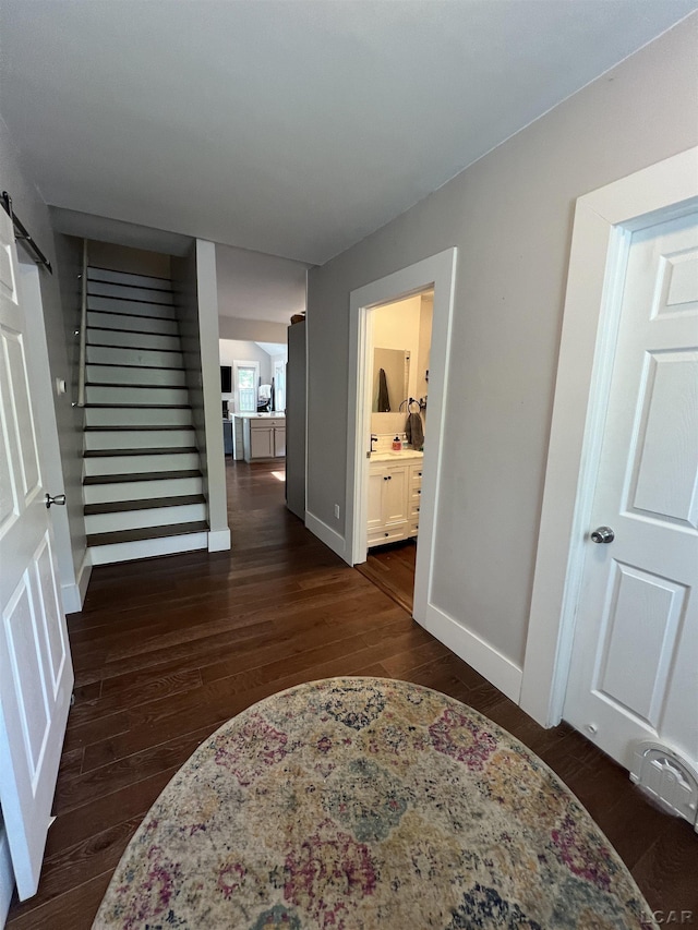 132 W Church St, Clinton, MI 49236 - hallway featuring stairway, dark wood finished floors, and a barn door