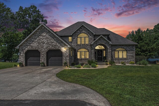 1256 Barron Lake Rd, Niles, MI 49120 - french country home featuring a garage, a yard, concrete driveway, and a shingled roof