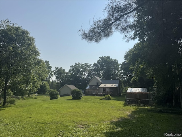 6351 Zimmer Rd, Haslett, MI 48840 - view of green lawn with an outdoor structure