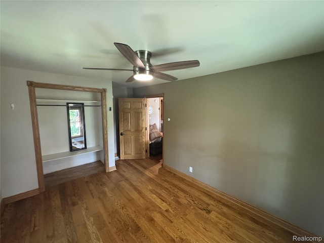 6351 Zimmer Rd, Haslett, MI 48840 - unfurnished bedroom with wood finished floors, a ceiling fan, and a closet