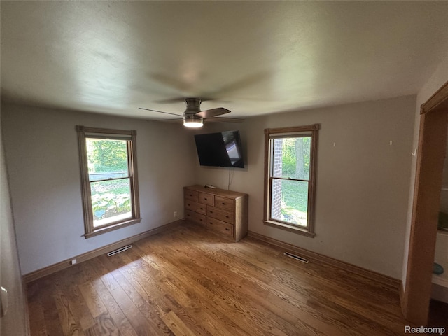 6351 Zimmer Rd, Haslett, MI 48840 - unfurnished bedroom with light wood-style floors and a ceiling fan