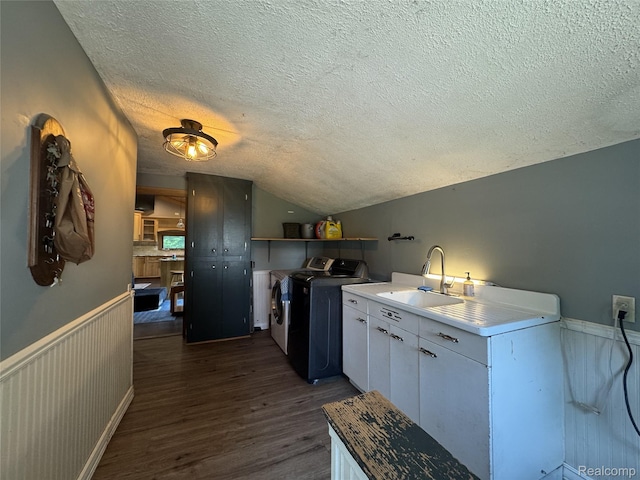 6351 Zimmer Rd, Haslett, MI 48840 - kitchen featuring washer and clothes dryer, a textured ceiling, dark wood-type flooring, lofted ceiling, and white cabinets