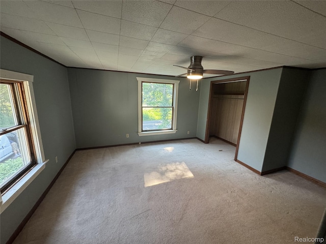 6351 Zimmer Rd, Haslett, MI 48840 - unfurnished bedroom with light carpet, crown molding, ceiling fan, and a closet