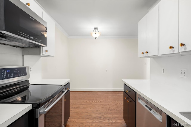 42309 Woodward Ave Unit S1-7, Bloomfield Hills, MI 48304 - kitchen with appliances with stainless steel finishes, light countertops, crown molding, and white cabinetry