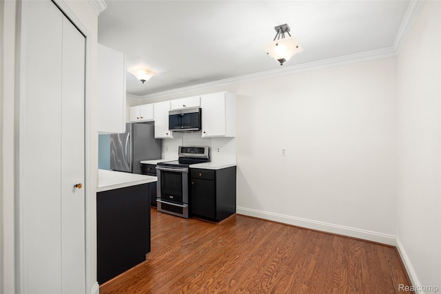 42309 Woodward Ave Unit S1-7, Bloomfield Hills, MI 48304 - kitchen featuring appliances with stainless steel finishes, light countertops, white cabinetry, wood finished floors, and ornamental molding