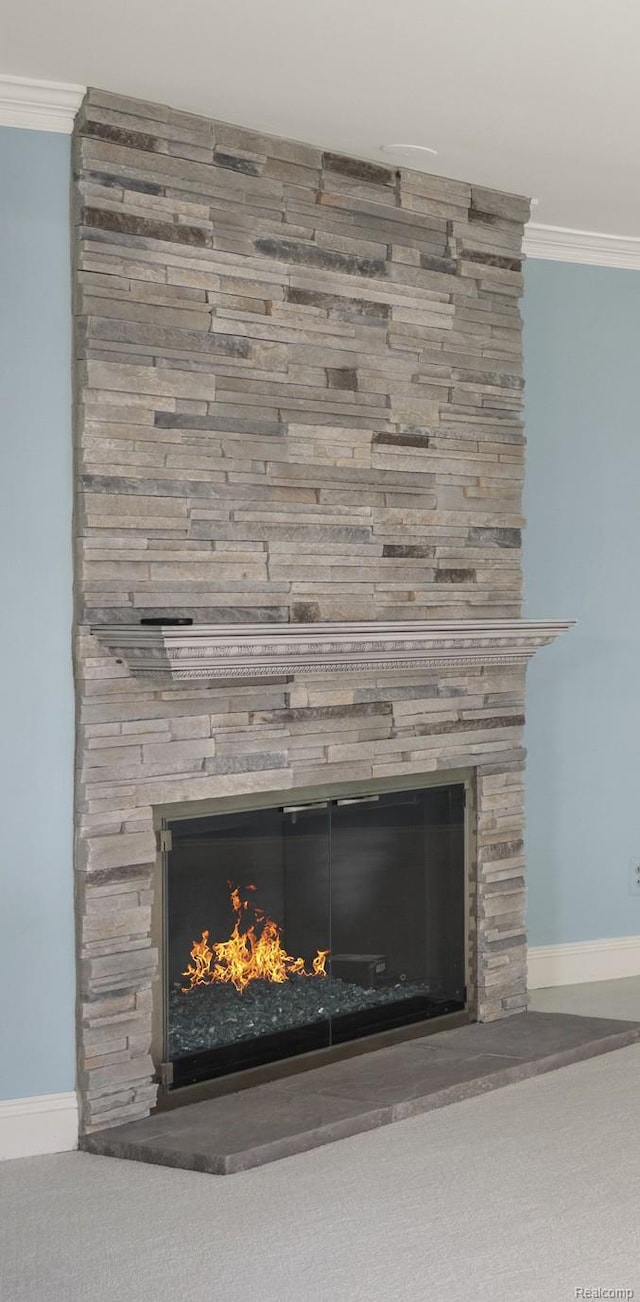 42309 Woodward Ave Unit S1-7, Bloomfield Hills, MI 48304 - detailed view of a stone fireplace, ornamental molding, and carpet floors