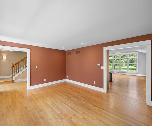 4641 Wylie Rd, Dexter, MI 48130 - empty room featuring light wood-style floors, stairway, and recessed lighting