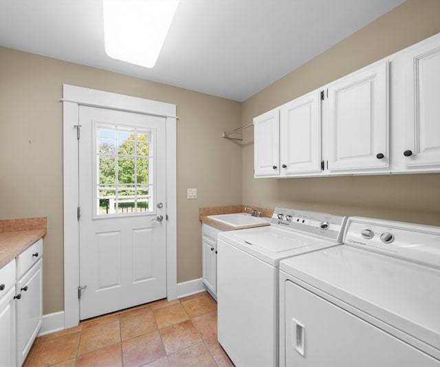 4641 Wylie Rd, Dexter, MI 48130 - laundry room with cabinet space, washer and dryer, and light tile patterned floors