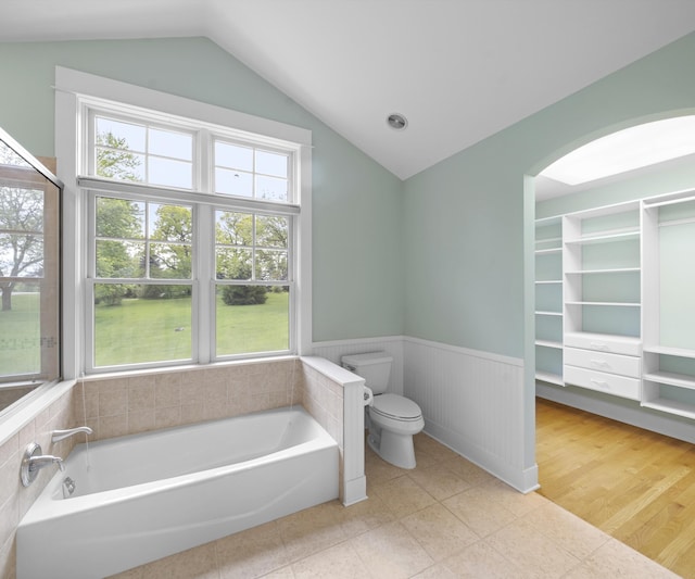 4641 Wylie Rd, Dexter, MI 48130 - full bathroom featuring wainscoting, a bath, and vaulted ceiling