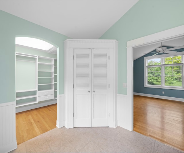 4641 Wylie Rd, Dexter, MI 48130 - unfurnished bedroom featuring wainscoting, tile patterned floors, and vaulted ceiling