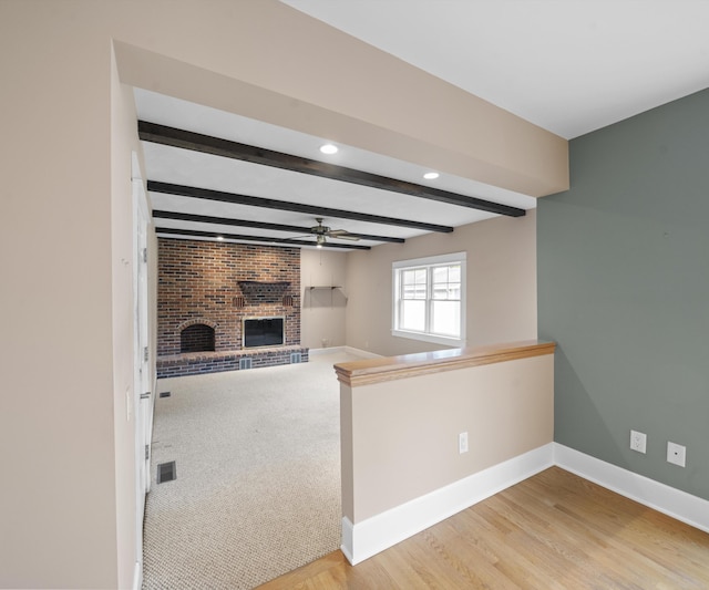4641 Wylie Rd, Dexter, MI 48130 - unfurnished living room featuring a fireplace, beamed ceiling, recessed lighting, wood finished floors, and ceiling fan