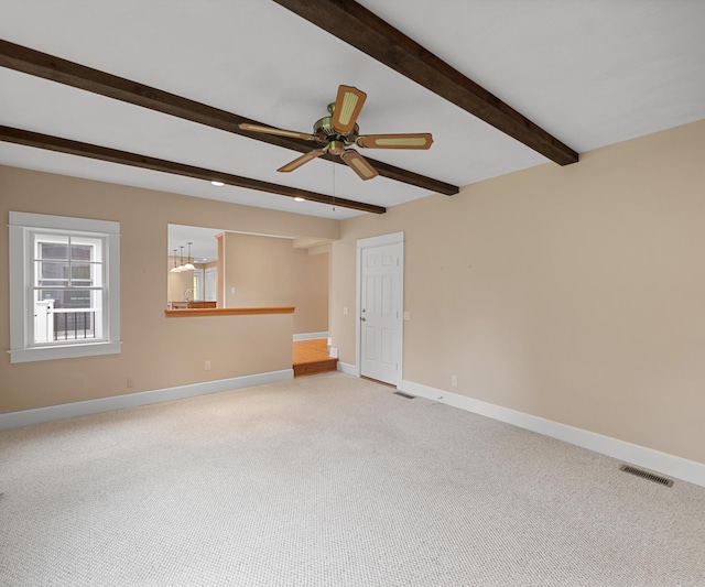 4641 Wylie Rd, Dexter, MI 48130 - unfurnished room with light carpet, beam ceiling, and ceiling fan