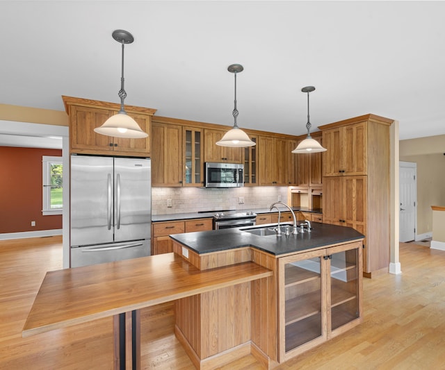 4641 Wylie Rd, Dexter, MI 48130 - kitchen with stainless steel appliances, dark countertops, decorative backsplash, and brown cabinets