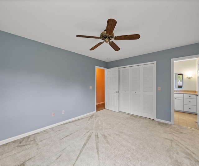 4641 Wylie Rd, Dexter, MI 48130 - unfurnished bedroom with light carpet, a closet, connected bathroom, and ceiling fan