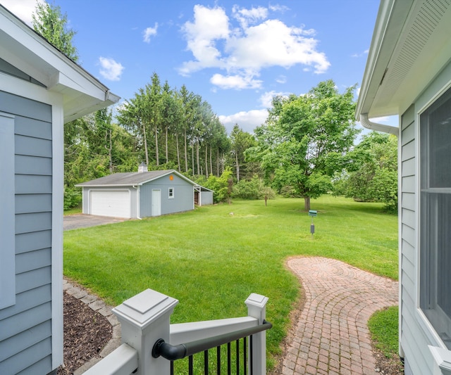 4641 Wylie Rd, Dexter, MI 48130 - view of green lawn featuring an outbuilding, a detached garage, and view of wooded area
