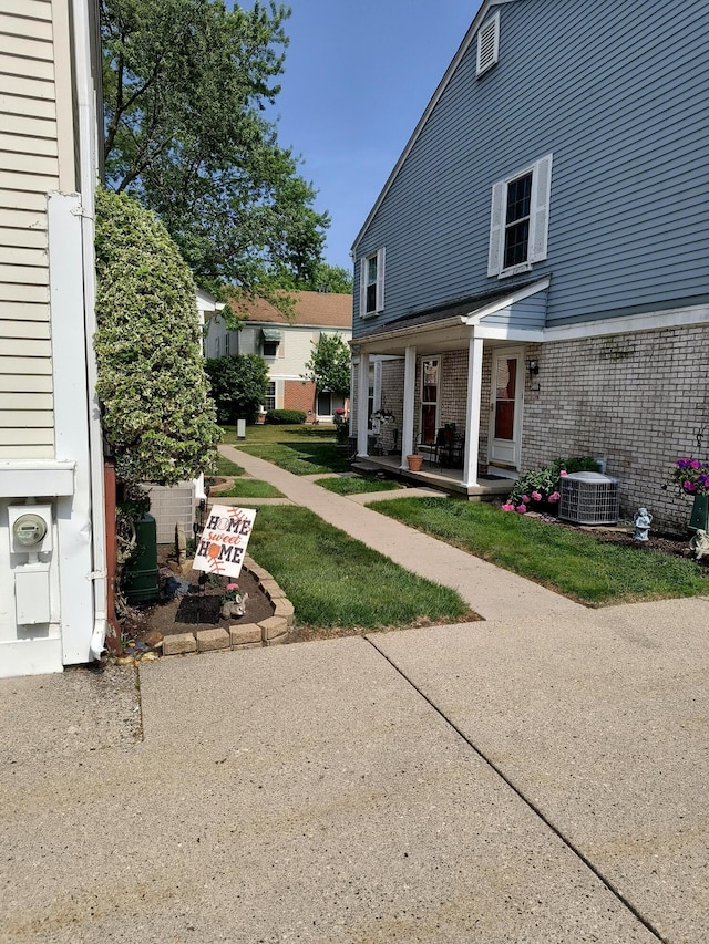 24654 Spring Ln, Harrison Township, MI 48045 - view of grassy yard with a porch