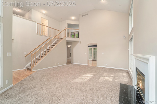 5200 Royal Vale Ln, Dearborn, MI 48126 - unfurnished living room with carpet flooring, stairway, high vaulted ceiling, and a fireplace with flush hearth