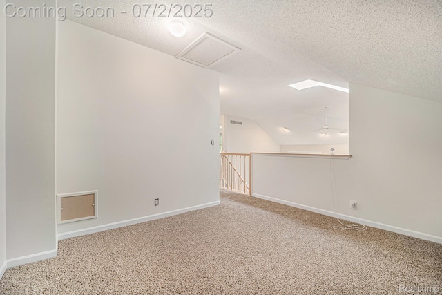 5200 Royal Vale Ln, Dearborn, MI 48126 - spare room featuring carpet flooring, a textured ceiling, attic access, and vaulted ceiling