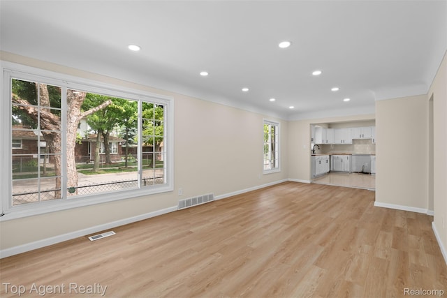 19005 Lister Ave, Eastpointe, MI 48021 - unfurnished living room featuring plenty of natural light, light wood-style flooring, and recessed lighting