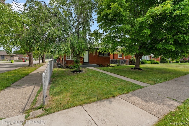 19005 Lister Ave, Eastpointe, MI 48021 - view of property hidden behind natural elements featuring brick siding and a front lawn