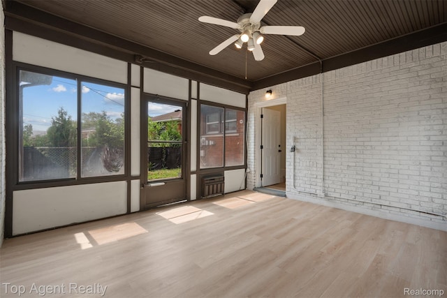 19005 Lister Ave, Eastpointe, MI 48021 - unfurnished room featuring brick wall, wood finished floors, plenty of natural light, wood ceiling, and a ceiling fan
