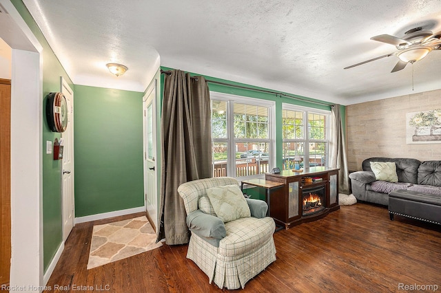 35221 Weideman St, Clinton Township, MI 48035 - living room featuring ceiling fan, wood finished floors, a fireplace, a textured ceiling, and an accent wall