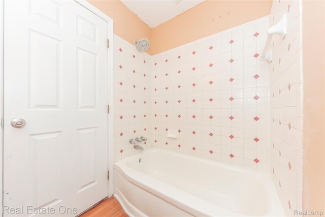31121 Avondale St, Westland, MI 48186 - bathroom featuring bathing tub / shower combination and wood finished floors