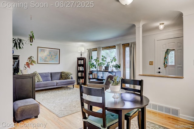 24745 Ross Dr, Redford, MI 48239 - dining room featuring wood finished floors and ornate columns