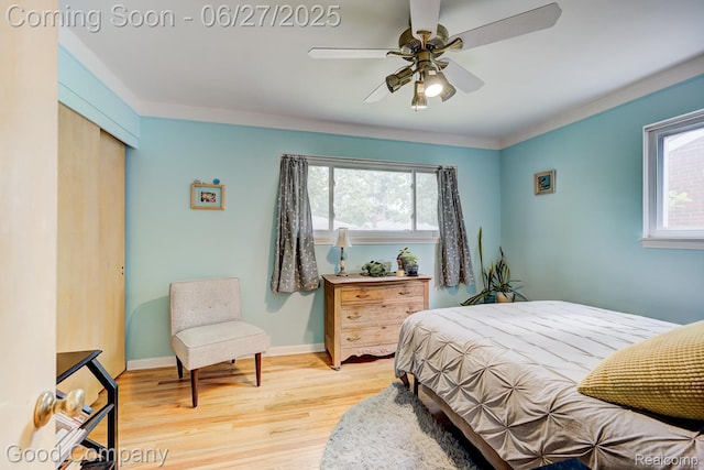 24745 Ross Dr, Redford, MI 48239 - bedroom featuring multiple windows, wood finished floors, a closet, and a ceiling fan