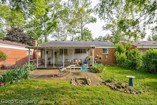 24745 Ross Dr, Redford, MI 48239 - rear view of property with a patio, a lawn, a chimney, and brick siding