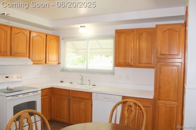 9396 Allen Rd, Allen Park, MI 48101 - kitchen featuring white appliances, under cabinet range hood, light countertops, and brown cabinetry
