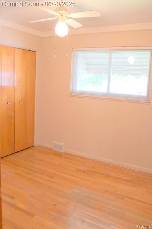 9396 Allen Rd, Allen Park, MI 48101 - unfurnished bedroom featuring light wood-type flooring, a closet, crown molding, and a ceiling fan
