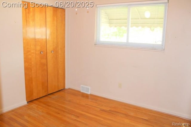 9396 Allen Rd, Allen Park, MI 48101 - unfurnished bedroom with light wood-style flooring and a closet