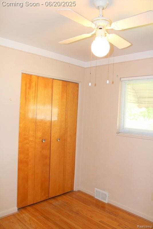 9396 Allen Rd, Allen Park, MI 48101 - unfurnished bedroom featuring a closet, light wood finished floors, and ceiling fan