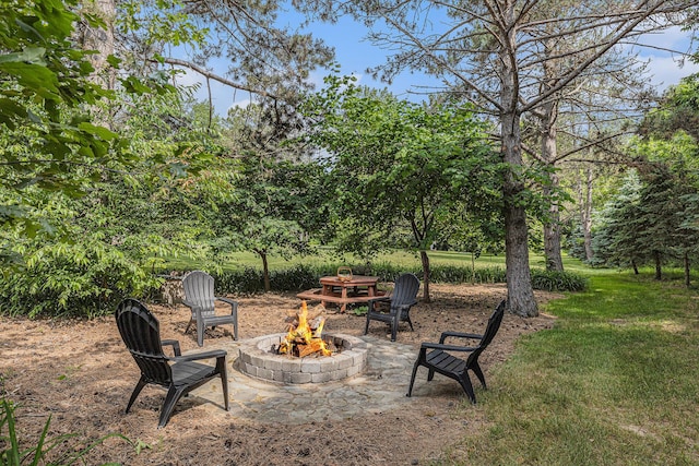 10310 E Rivershore Dr SE, Alto, MI 49302 - view of patio with an outdoor fire pit