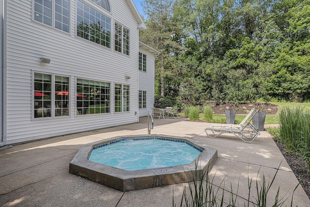 10310 E Rivershore Dr SE, Alto, MI 49302 - view of swimming pool with an in-ground hot tub and a patio