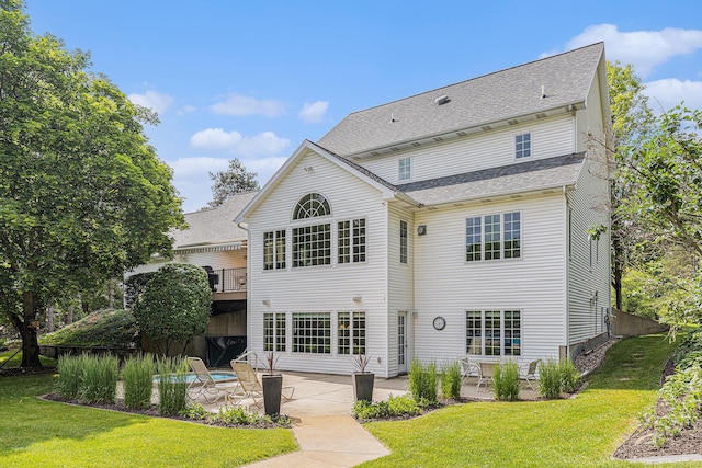 10310 E Rivershore Dr SE, Alto, MI 49302 - back of property with a patio area, a lawn, and a shingled roof