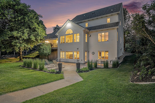 10310 E Rivershore Dr SE, Alto, MI 49302 - back of house with a patio area and a lawn