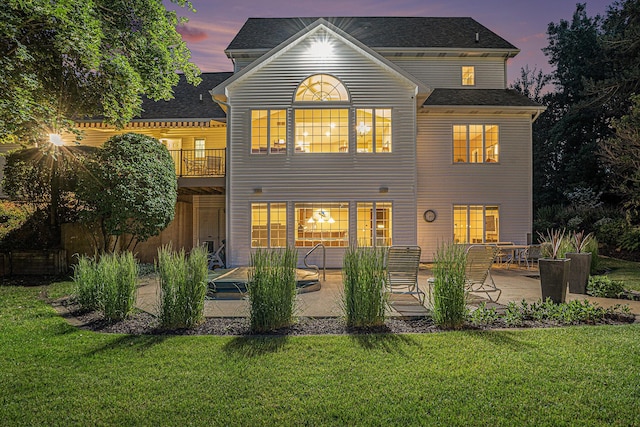 10310 E Rivershore Dr SE, Alto, MI 49302 - back of property at dusk with a patio area, a yard, and a balcony