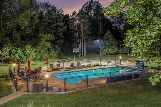10310 E Rivershore Dr SE, Alto, MI 49302 - pool at dusk featuring a water slide and a patio area