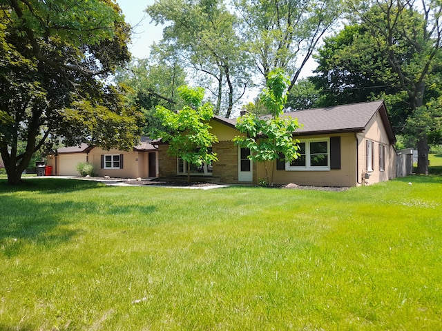 5615 Carlburt St, West Bloomfield, MI 48322 - view of front of home featuring an attached garage and a front yard