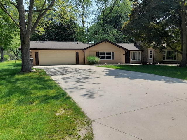 5615 Carlburt St, West Bloomfield, MI 48322 - ranch-style house with concrete driveway, a garage, and a front yard