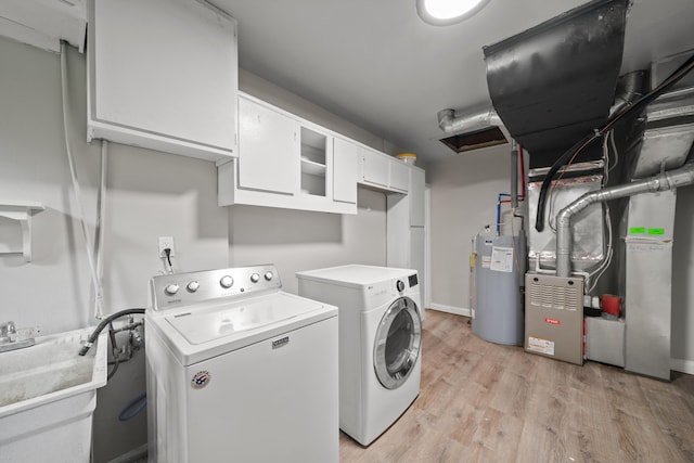 5615 Carlburt St, West Bloomfield, MI 48322 - laundry area featuring water heater, cabinet space, separate washer and dryer, light wood-type flooring, and heating unit